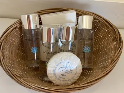 a basket with four bottles of soap and a moisturizer at Grey Mullet Guest House in St Ives