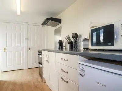 a kitchen with a microwave and a counter top at Narnia in Delabole
