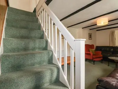 a staircase in a house with a living room at Narnia in Delabole
