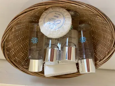 a basket filled with toothpaste and toothbrushes at Grey Mullet Guest House in St Ives