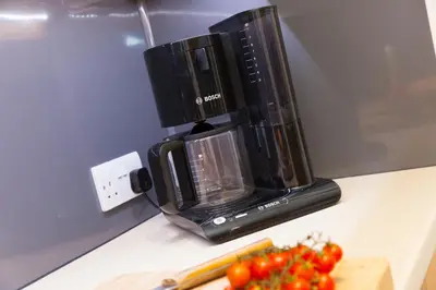a blender sitting on a counter next to a pile of tomatoes at Oystercatcher House in St Ives