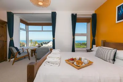 a bedroom with a bed with a tray of fruit on it at Oystercatcher House in St Ives