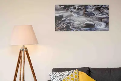 a lamp in a living room next to a couch at Fishermans Heights in Polperro