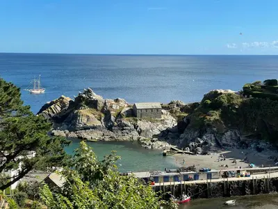 a view of a beach with a boat in the water at Fishermans Heights in Polperro