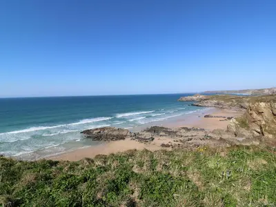 a beach with rocks and the ocean on a clear day at Dunes View in Newquay