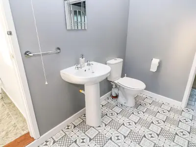 a bathroom with a sink and a toilet at Dunes View in Newquay