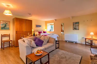 a living room with a couch and a table at Finest Retreats - Jenny Wren in Boscastle