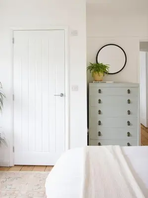 a bedroom with a bed and a dresser with a mirror at The Palm House Falmouth - minutes from the beach! in Falmouth