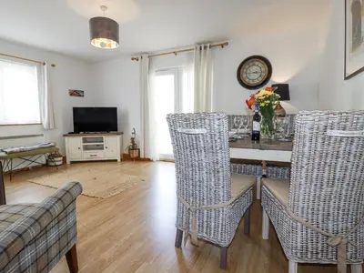 a living room with a table and chairs at Flat 4 in Newquay
