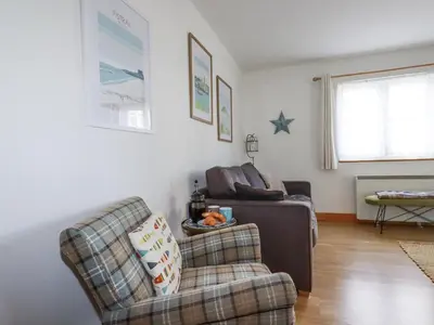 a living room with a couch and a chair at Flat 4 in Newquay