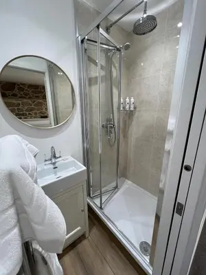 a bathroom with a shower and a sink at The White House at The Tinners Arms in St Ives