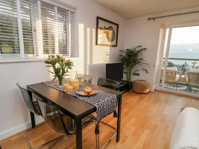 a living room with a table with oranges on it at A Stone's Throw in Torpoint