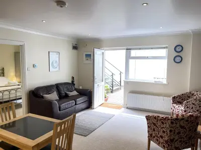 a living room with a couch and a table at Penryn in St Ives