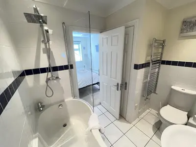 a bathroom with a tub and a toilet and a shower at Penryn in St Ives