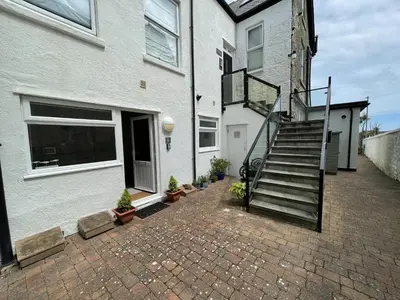 a house with a staircase next to a building at Penryn in St Ives