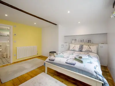 a bedroom with a large bed in a room at Holiday Home Cherry Orchard Cottage by Interhome in Mevagissey