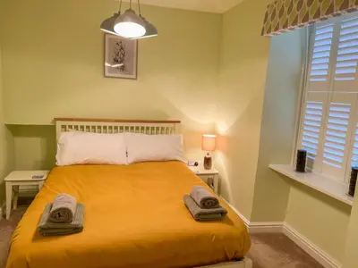 a bedroom with a bed with two towels on it at Holiday Home Cherry Orchard House by Interhome in Mevagissey