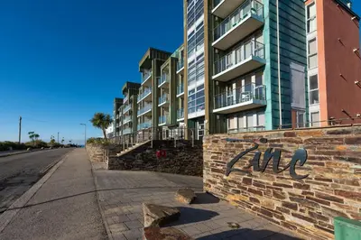 a brick wall with the word end written on it next to a building at 22 Zinc in Newquay