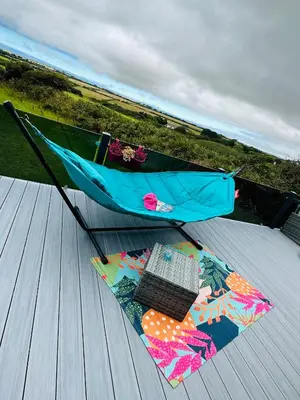 an umbrella and a keyboard on a wooden deck at C-Scape Lodge in Newquay