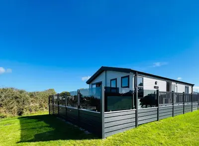 a modern house with a black and white exterior at C-Scape Lodge in Newquay
