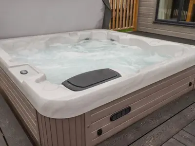 a jacuzzi tub sitting on top of a deck at Mordros Lodge in Redruth
