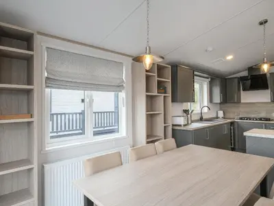 a kitchen with a wooden table and a window at Penmarlam Lodge Retreat 18 in Fowey