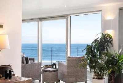 a living room with a view of the ocean at Shore Edge in Portreath