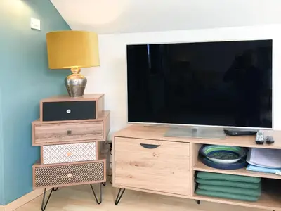 a wooden entertainment center with a flat screen tv at Little Fursdon Apartment in Liskeard