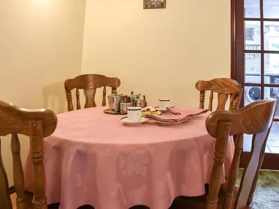 a table with a pink table cloth on it at Anneth Lowen in Perranwell