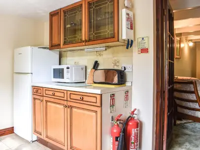 a kitchen with a microwave and a refrigerator at Anneth Lowen in Perranwell