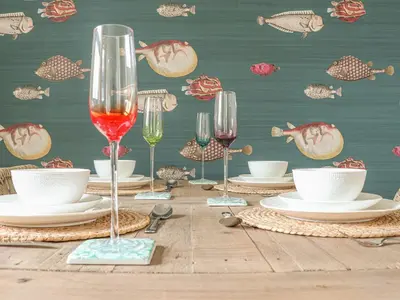 a wooden table with glasses of wine and plates at The Old Smokehouse in St Austell