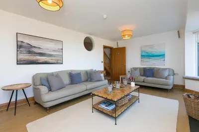 a living room with two couches and a coffee table at Beachcroft in St Ives
