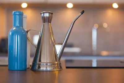 a tea kettle and a blue bottle on a table at Beachcroft in St Ives