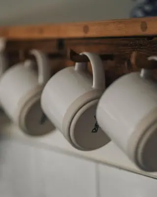 a row of white headphones sitting on a shelf at Swallows Nest at Widemouth Bay - 2 bedroom cottage in Bude