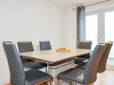 a conference room with a wooden table and chairs at 6B The Mews in Padstow