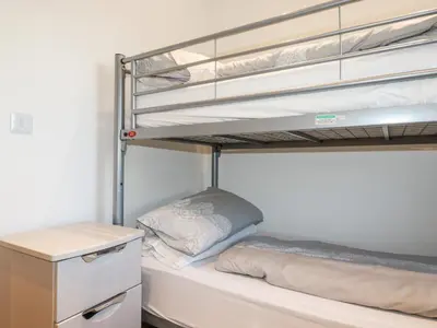 a bedroom with two bunk beds and a desk at 6B The Mews in Padstow