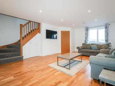 a living room with a couch and a table at 6B The Mews in Padstow
