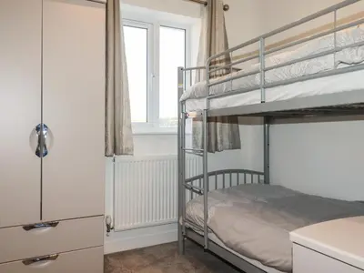 a bedroom with two bunk beds and a window at 6A The Mews in Padstow