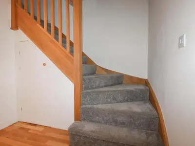 a staircase in a house with a gray carpet at 6A The Mews in Padstow