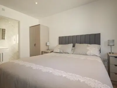 a bedroom with a large white bed with white pillows at 6A The Mews in Padstow