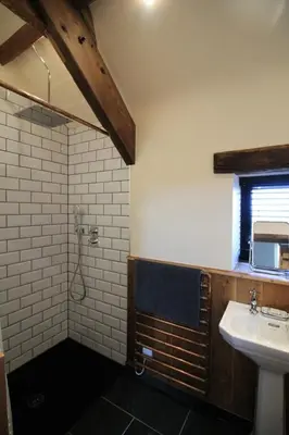 a bathroom with a sink and a shower at The Stable at Widemouth Bay - 2 bedroom cottage in Poundstock