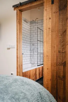a bathroom with a shower in a room at The Stable at Widemouth Bay - 2 bedroom cottage in Poundstock