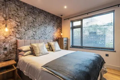 a bedroom with a large bed and a window at Porthleven View in Porthleven
