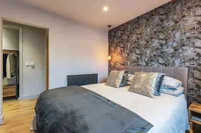 a bedroom with a large white bed with pillows at Porthleven View in Porthleven