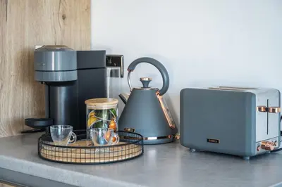 a kitchen counter with a coffee maker and a toaster at Porthleven View in Porthleven