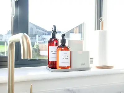 two bottles of alcohol sitting on a window sill at Rosefern in Tintagel