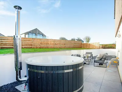 a bath tub sitting on top of a patio at Rosefern in Tintagel