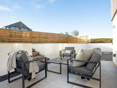 two chairs and a table on a patio at Rosefern in Tintagel