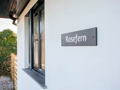 a sign for a restaurant on the side of a building at Rosefern in Tintagel