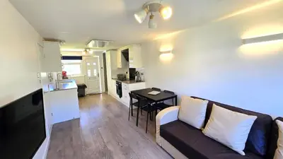a living room with a couch and a kitchen at 12 Wheal Ramoth in Perranporth